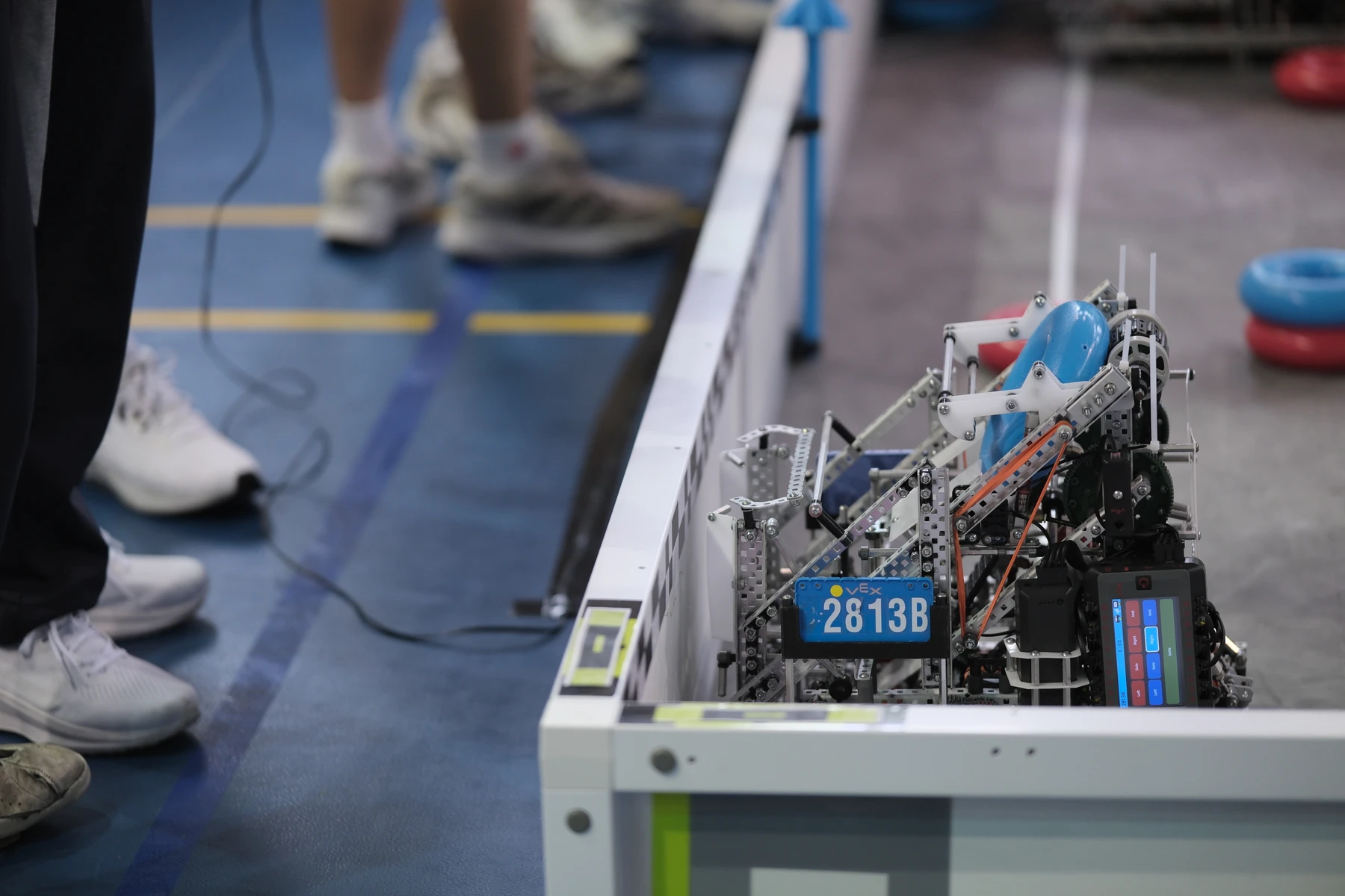 The first iteration of our robot, staged at the field wall and ready for a match.